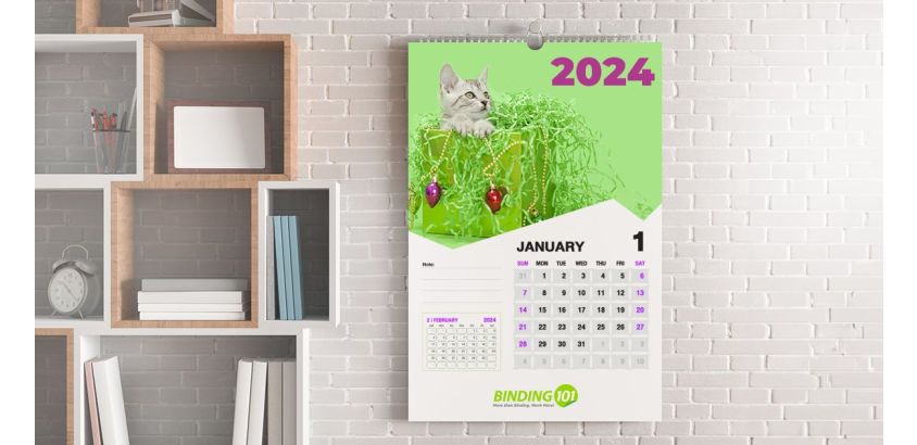 Wire calendar hanging in a home office next to a bookshelf.