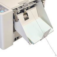 A close-up of the MBM AC0647 Micro-Perforator Add-On attachment positioned on a machine.