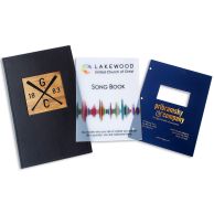 Custom Binding Report Covers featuring a black leather cover with a wooden emblem, a clear cover for a songbook with a colorful wave design, and a navy blue cover with a die-cut window and gold foil text for a professional look.