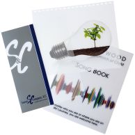 Three professionally printed Custom Poly Report Covers are displayed, each showcasing different full-color graphics and text, with one featuring a lightbulb and plant design and another a company logo on a dark spine binding.