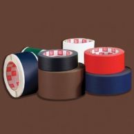 Multiple rolls of colored adhesive tapes, including a prominently placed roll of brown fabric book repair tape among other colors like red, blue, green, black, and white.