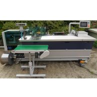 The James Burn CB40B Automatic Plastic Coil Forming & Binding Machine is shown with a touchscreen control panel, a coil supply reel, and an integrated conveyor system designed for high-volume coil binding operations.