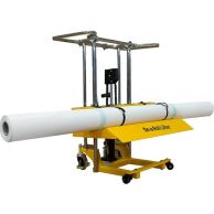 A yellow industrial roll lifter with chrome handles and a "On-a-Roll Lifter" label is holding a large white roll securely with two black straps.