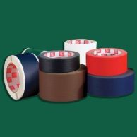 A collection of adhesive tapes in various colors, including a roll of green fabric book repair tape partially visible behind rolls of white, black, brown, red, and blue tape.