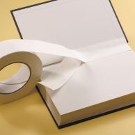 A roll of Kapco® Easy Bind® Tyvek® hinge repair tape is being applied along the inner hinge of a hardcover book to reinforce and secure the binding.