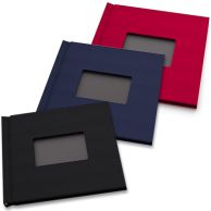 Three 8" H x 8" W Square Pinchbook™ Hardcover Photo Books with Window in black, navy blue, and red are stacked in a fanned layout, each featuring a centered rectangular cutout on the front cover.
