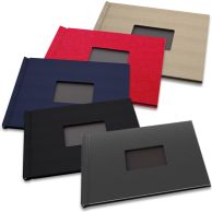 A variety of 8-1/2" H x 11" W Landscape Pinchbook™ Hardcover Photo Books with Window, shown in different colors including black, navy, red, and beige, each featuring a rectangular window on the cover.