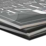 Stack of Pressure-Sensitive Foam Core Pouch Boards with Matte finish displaying mounted graphics on both white and black foam cores with a soft, glare-free surface.