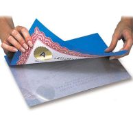 Hands are applying a certificate to a 1-Sided Cold Self-Laminating Sheet using a blue backing for easy alignment and protection.