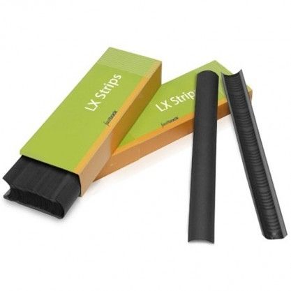 Two Black Fastback LX Binding Strips for Model 9 are positioned beside an open green and orange LX Strips box, with more strips neatly stacked inside the package.