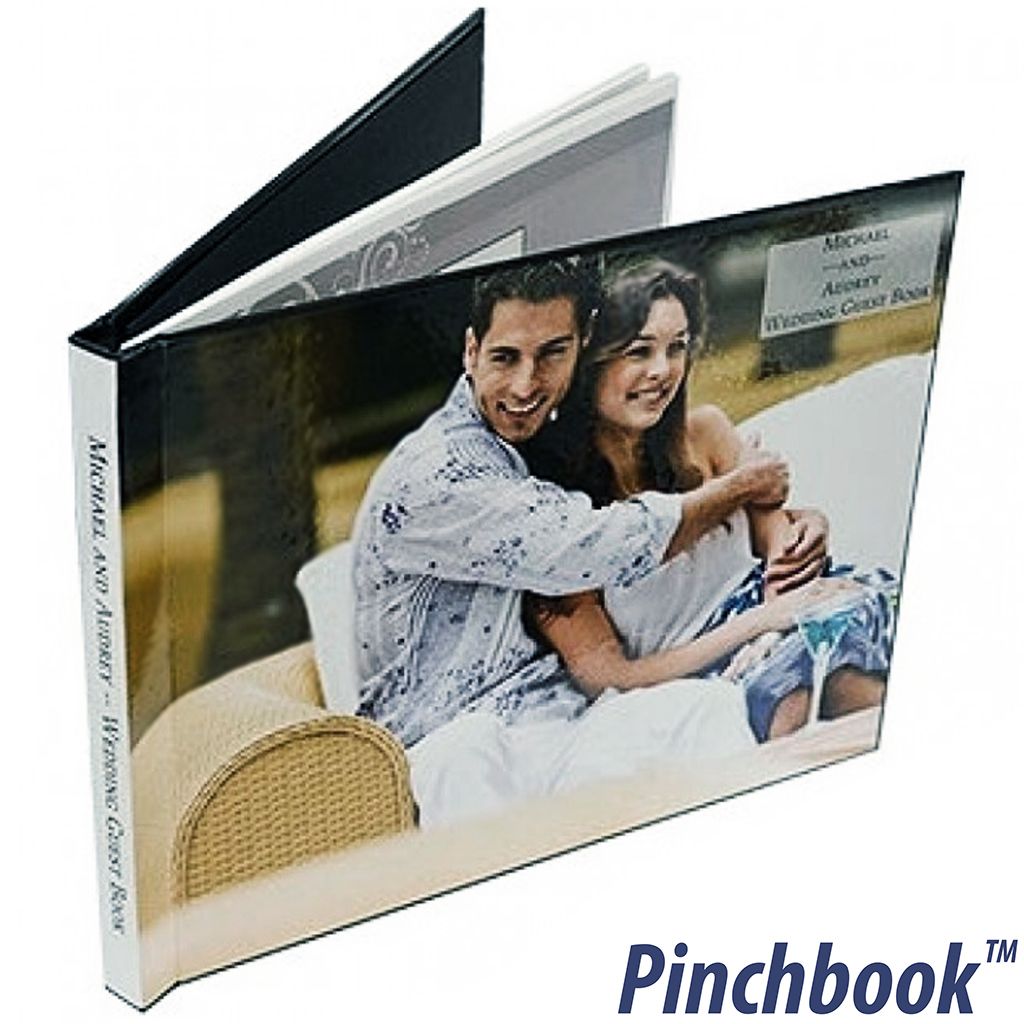 A wedding-themed photo album featuring a smiling couple on the front is bound using Custom Pinchbook™ Photo Book Covers, with a glossy, full-color wraparound design and spine text.