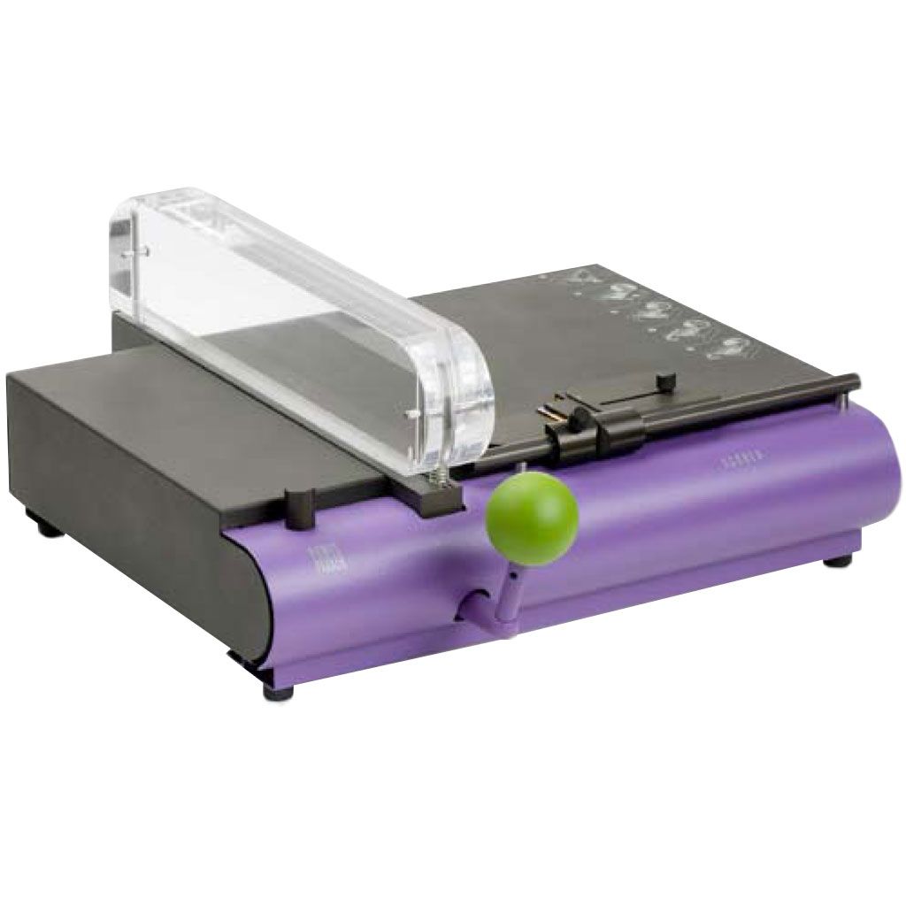 The Fastback SM1 Single-Score Creaser Machine for Paperback Book Covers features a compact design with a purple base, a green lever handle, and a transparent scoring guide.