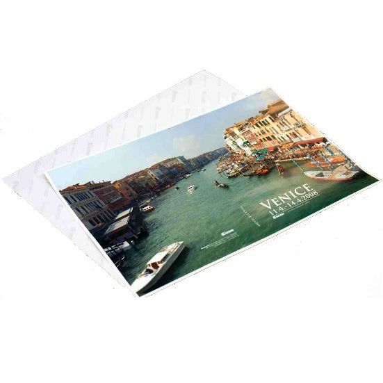 A printed Venice cover is placed on top of Fastbind Hard Cover Tacking Sheets, displaying the adhesive sheets partially underneath.
