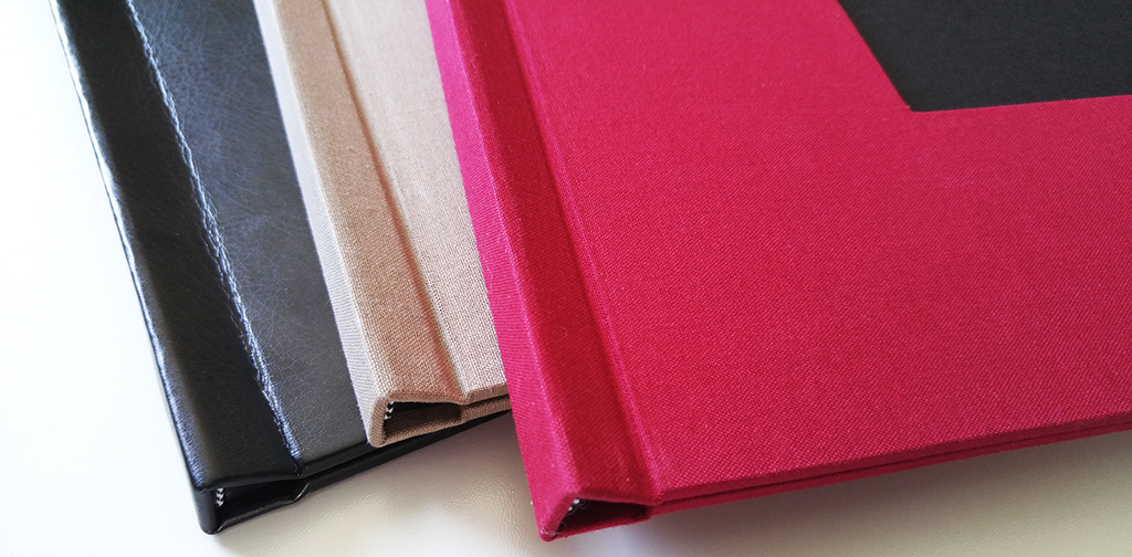 Close-Up of Pinchbook Photo Books - Various Sizes and Colors of Linen Hard Cover DIY Photobooks