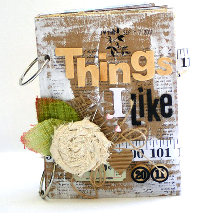 A handmade scrapbook titled "Things I Like," featuring rustic embellishments and bound together with binding rings.