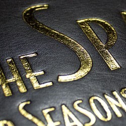Close-up of a binder featuring a deboss with foil stamp design in gold.