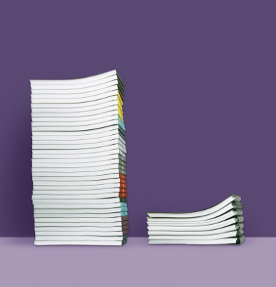 A comparison of stacked documents highlights that the Fastback 20 binds 3.5x faster than competitive binding systems.