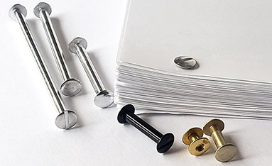 A set of documents bound with aluminum Chicago screw-posts in various sizes and colors on a white surface.